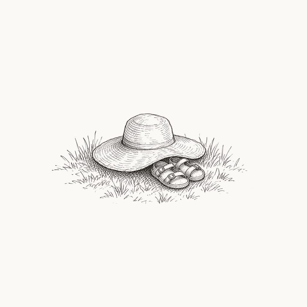 Pen sketch of a woman's sun hat and a child's tiny sandals in the grass