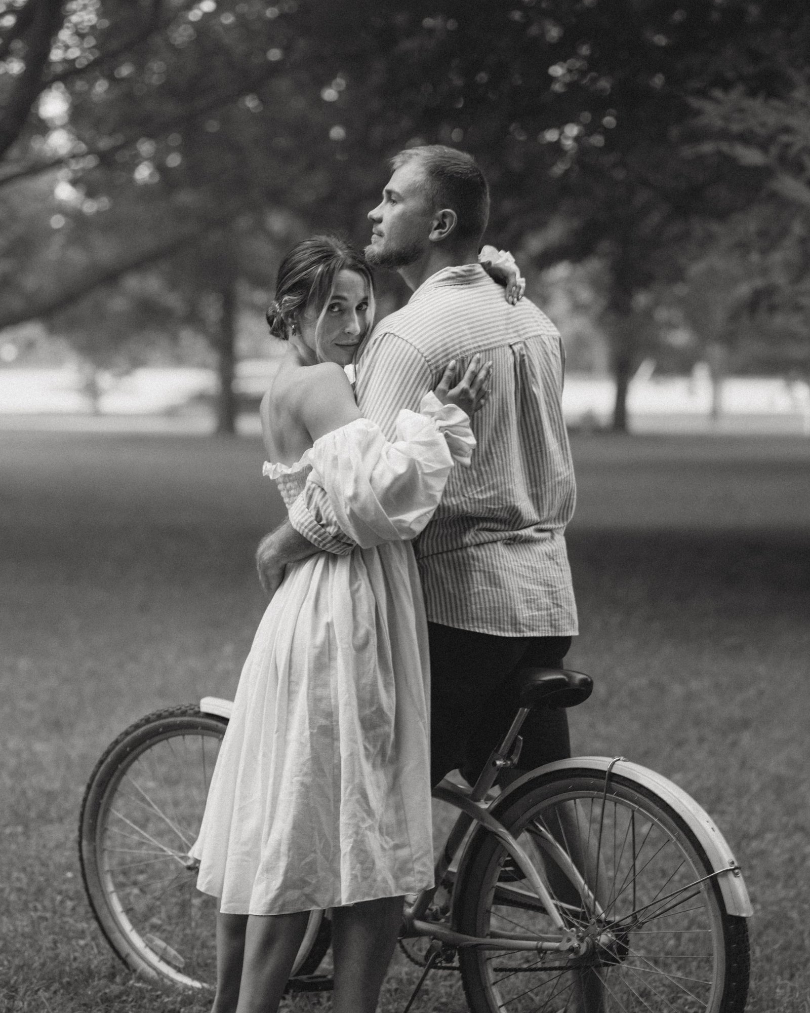 A black and white portrait of a couple looking at one another