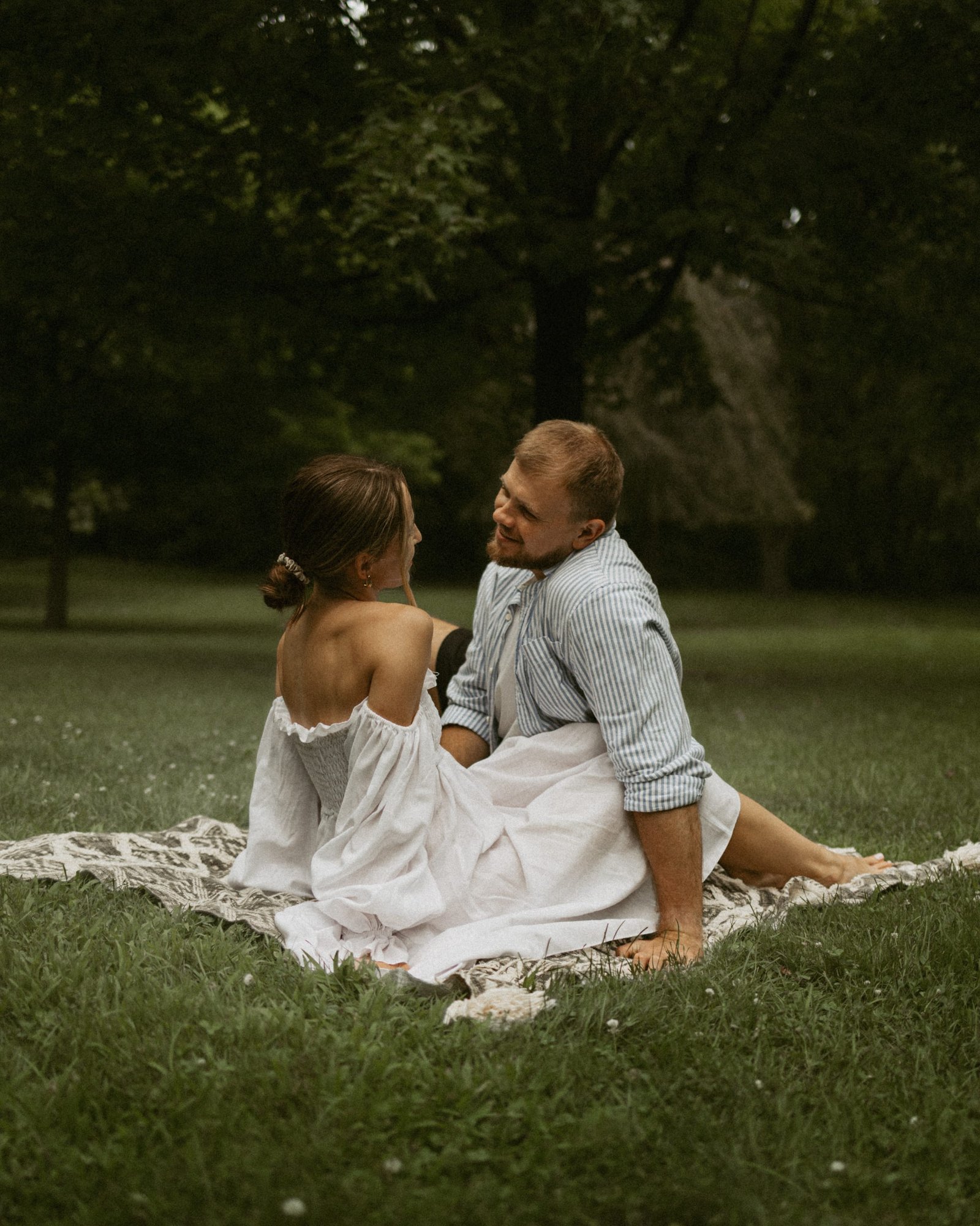 A man leaning down to his partner's face as she looks up at him
