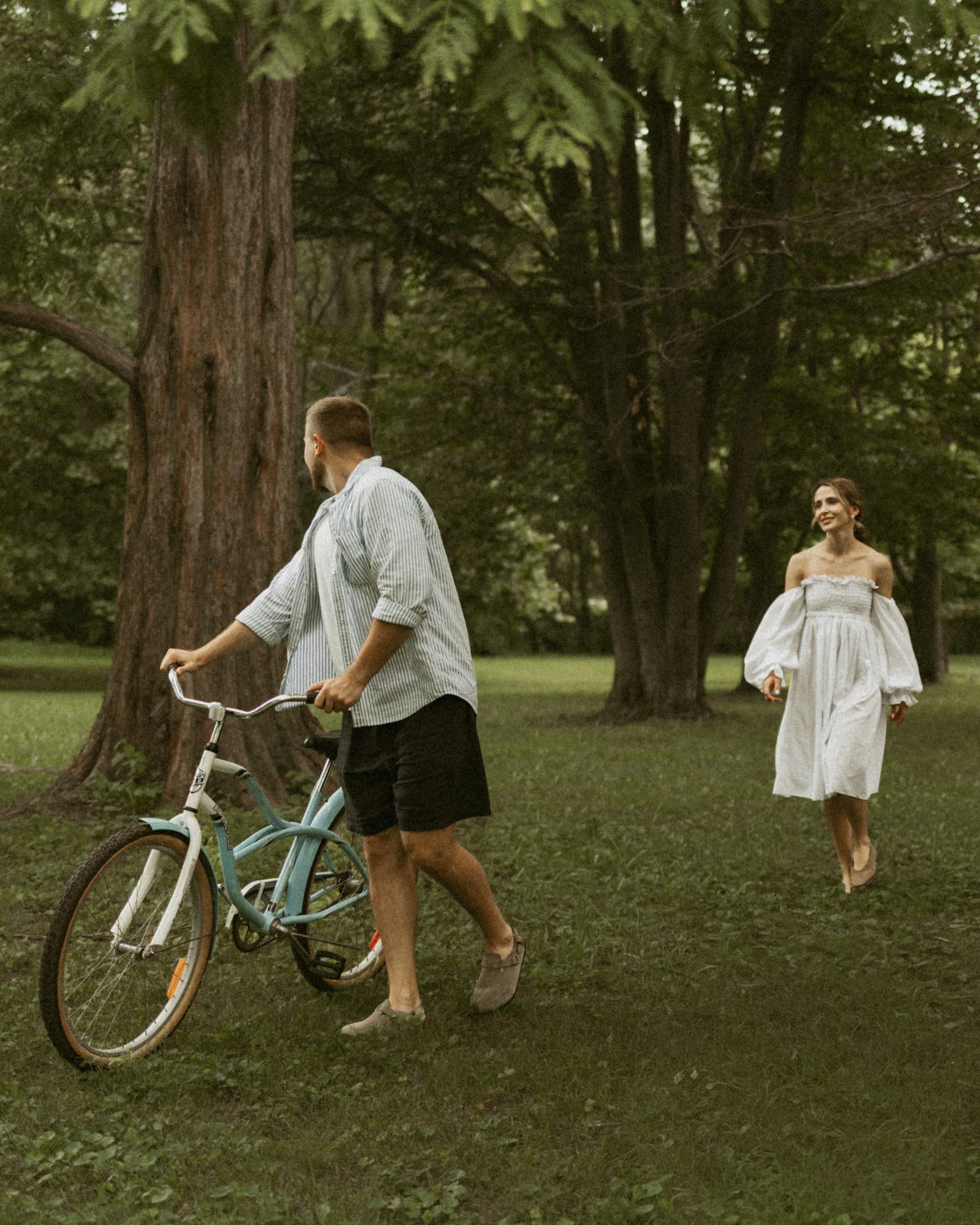 A man lifting his partner off her feet, her dress catching the air